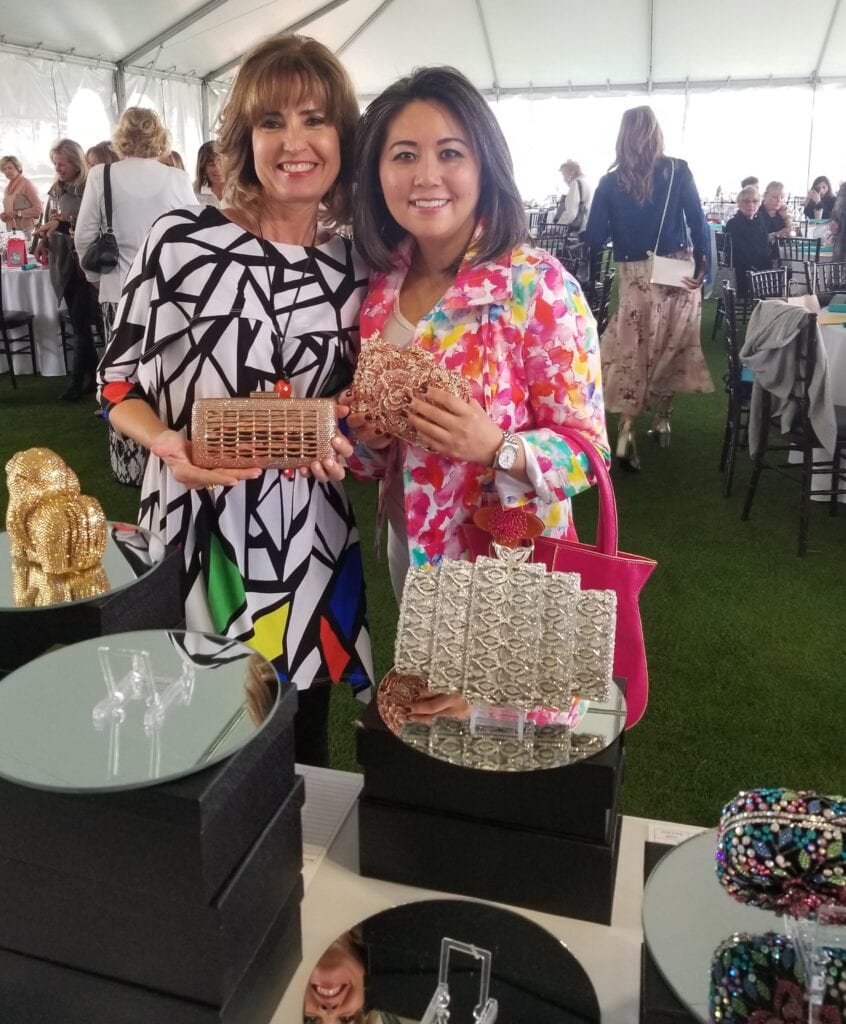 two women holding Swarovski crystal purses