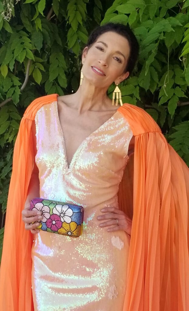woman holding a Swarovski crystal purse with flowers
