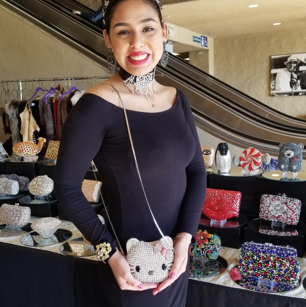 woman with a hello kitty Swarovski crystal purse