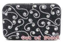 Close-up of black fabric with white swirly pattern.