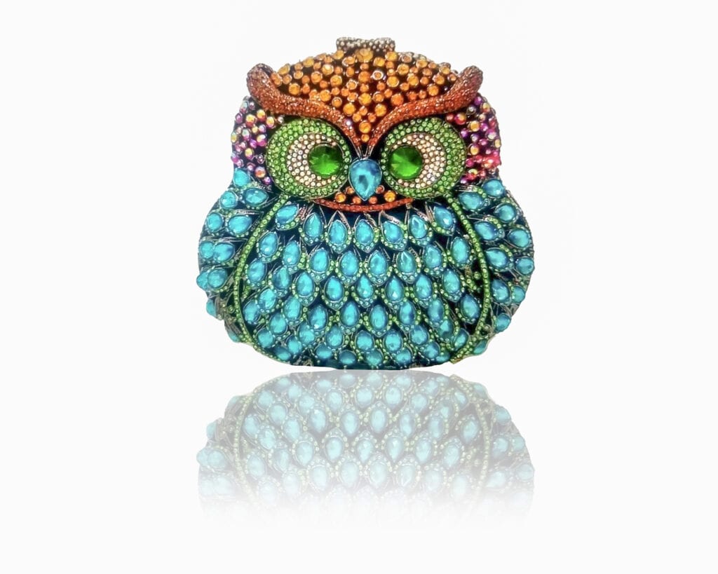 Colorful jeweled owl brooch with green eyes and multicolored stones.