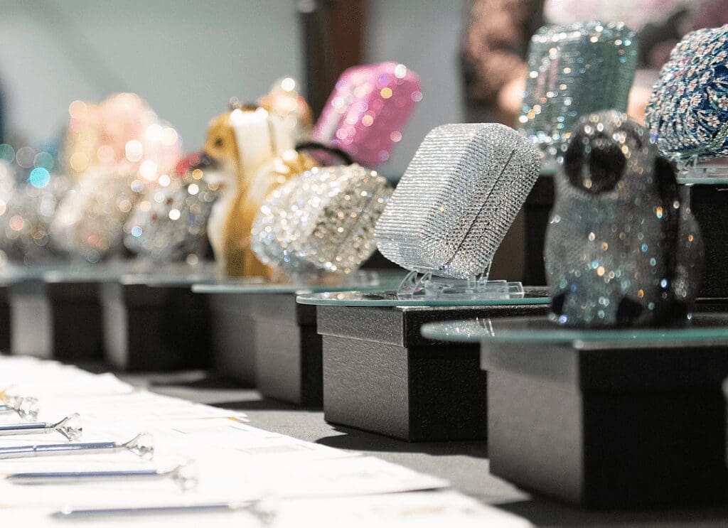 table with paper and Swarovski crystal purses