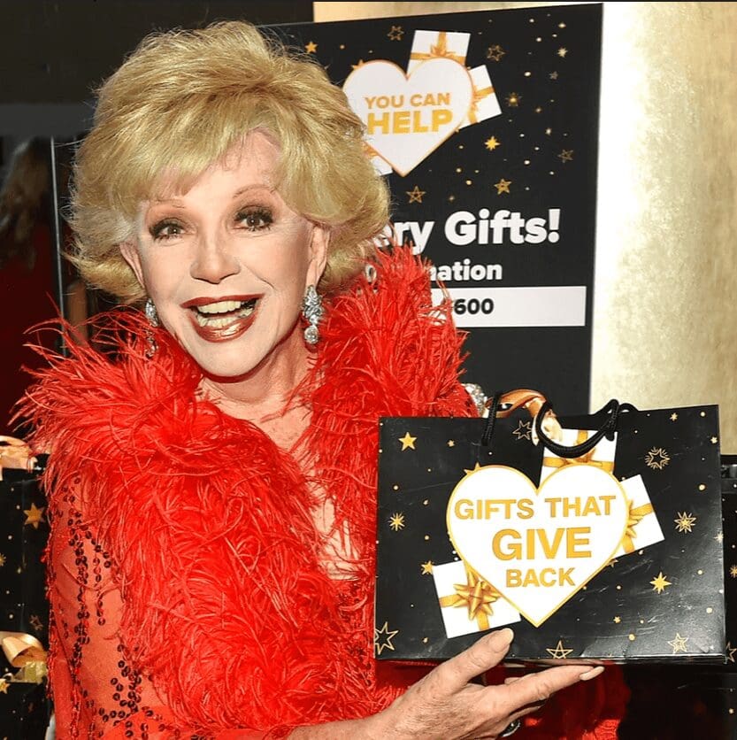 woman holding black gift bag