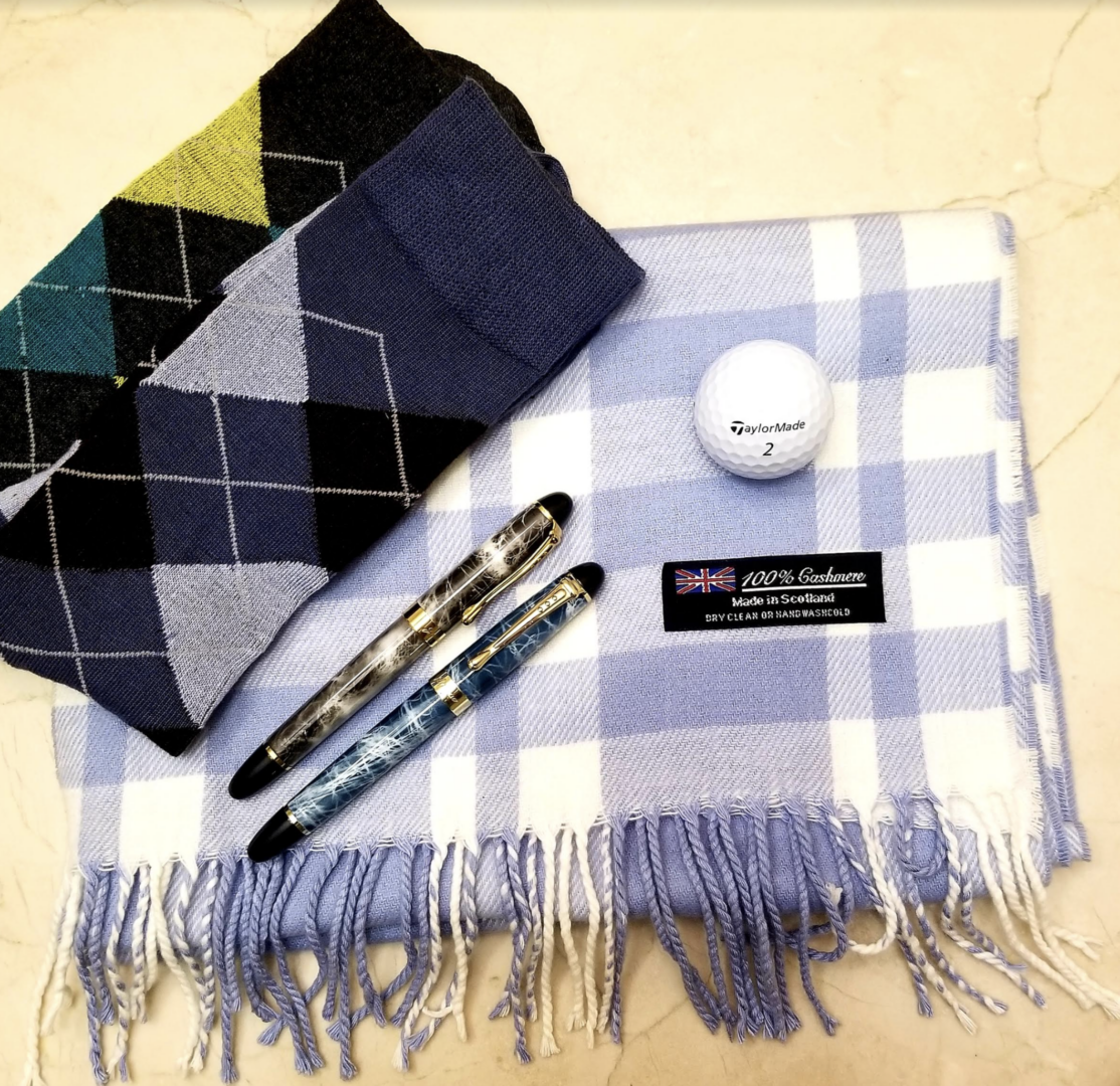 flat lay of socks and cashmere scarf with pens and golf ball 5