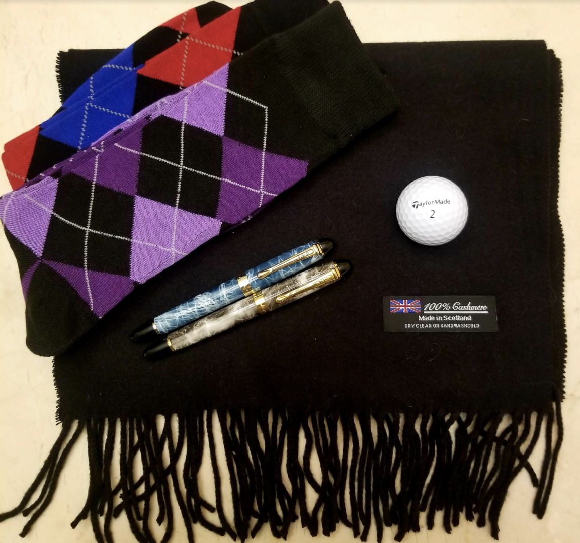 flat lay of socks and cashmere scarf with pens and golf ball 2