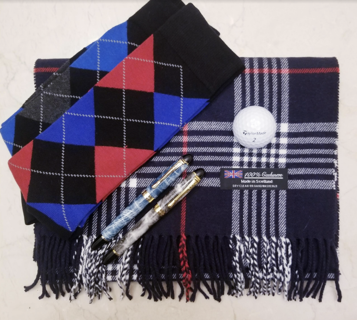 flat lay of socks and cashmere scarf with pens and golf ball