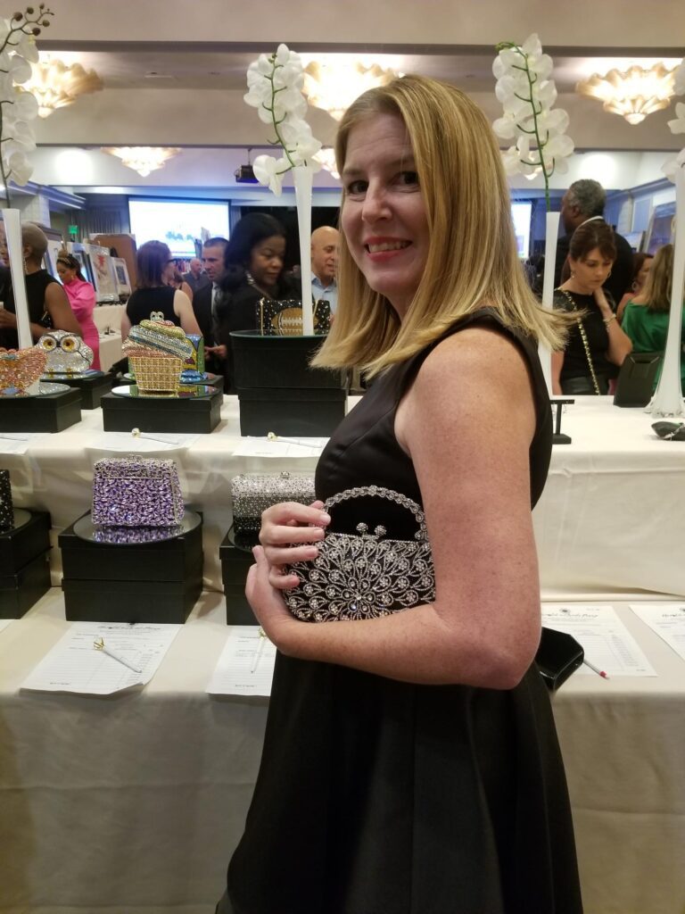 woman carrying black and white Swarovski crystal purse