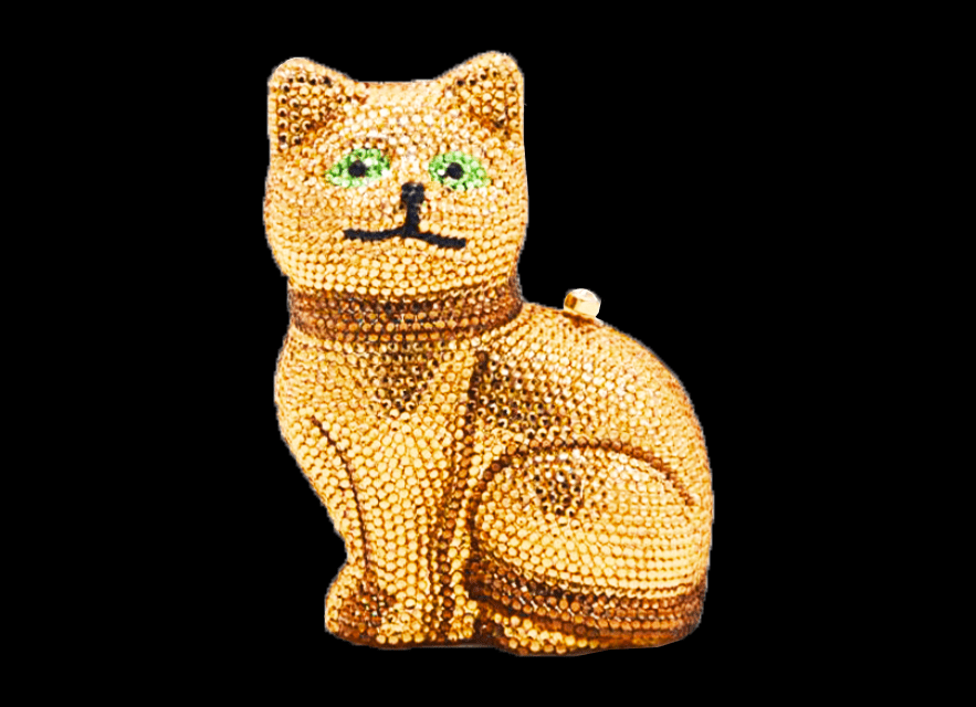 A small, carved wooden cat figurine with painted details.