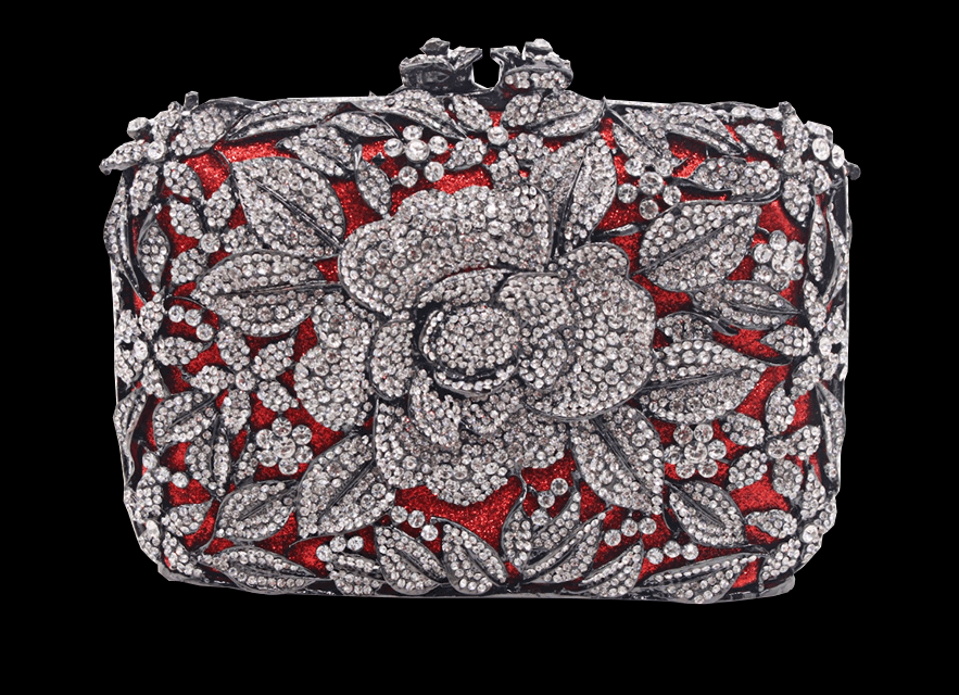 Intricately designed clutch with silver floral patterns and red background.